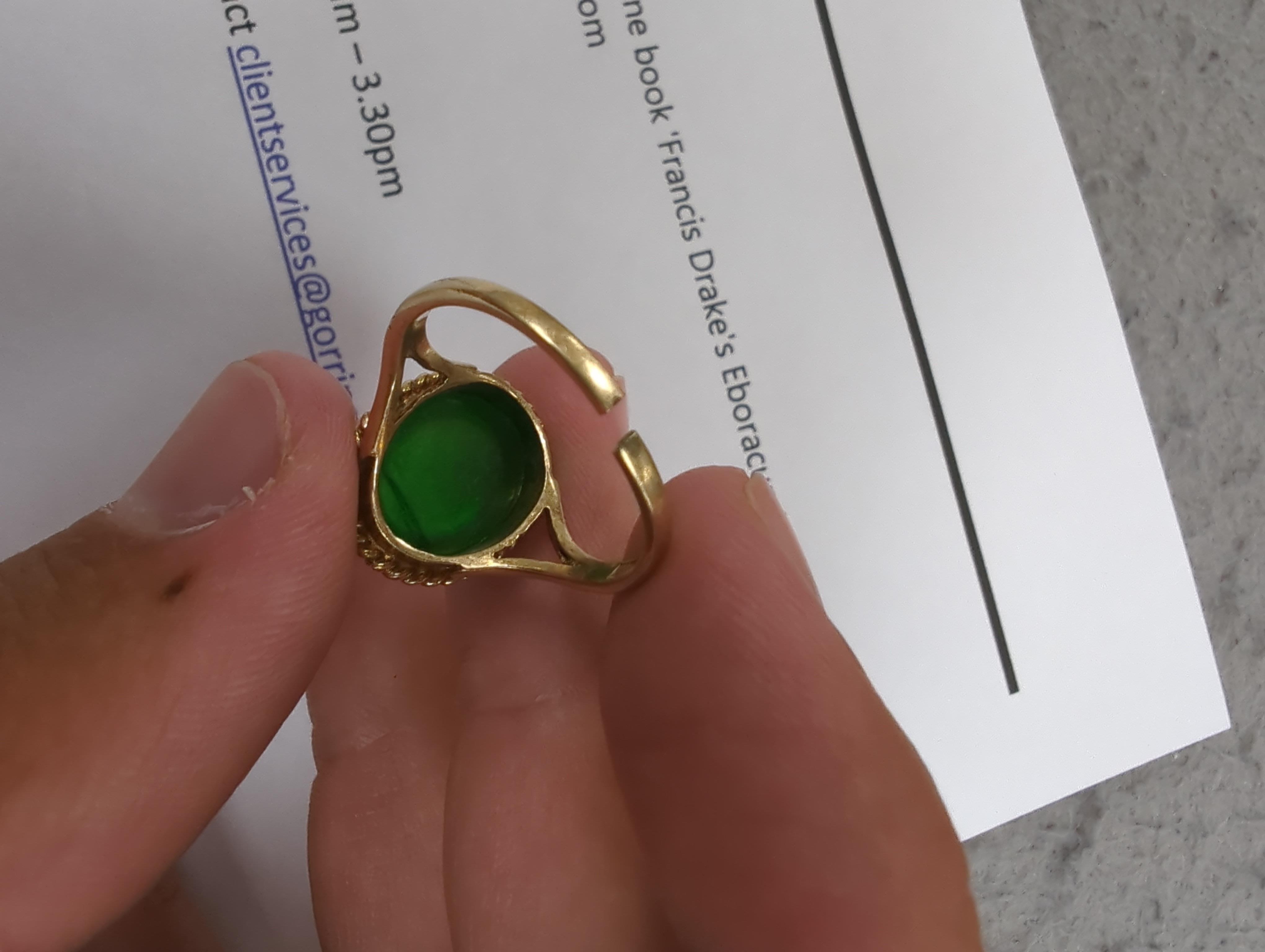 A 9ct gold and cabochon jade set oval ring (shank cut), gross weight 4.3 grams.